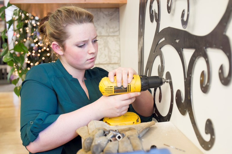 Paisley Hayes installs a peace tree for the Olds Rotary Club at the Olds Municipal Library on Nov. 30.