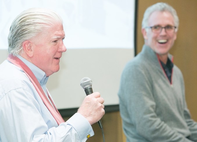 Calgary Flames president of hockey operations Brian Burke answers a question as Craig MacTavish of the Edmonton Oilers looks on during a fundraiser for the Every Kid Every