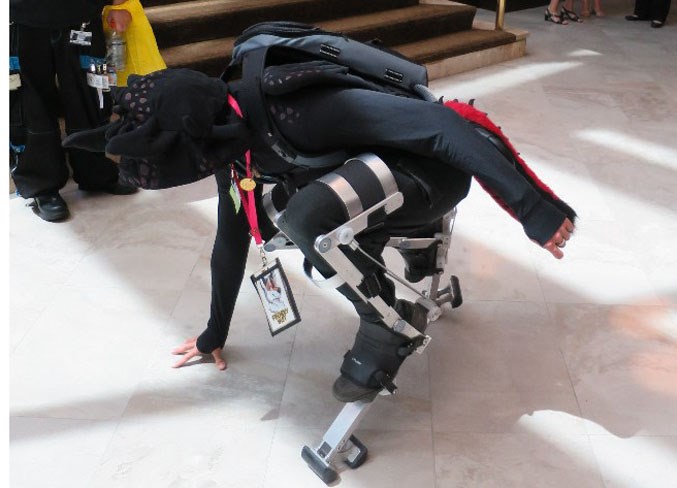A model squats down on werewolf stilts.
