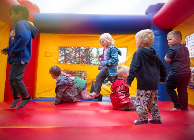 Children play in a bounce house during the event.