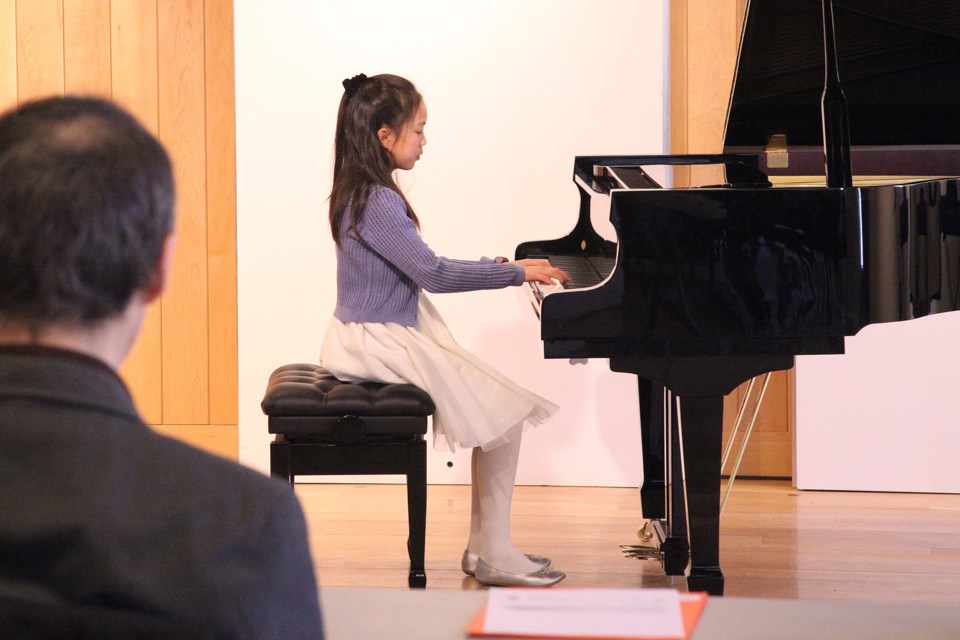Annie Chung begins her Piano Level 9 List A performance for adjudicator Frank Horvat at the Newmarket Lions Music Festival this week at the Old Town Hall.  Greg King for NewmarketToday