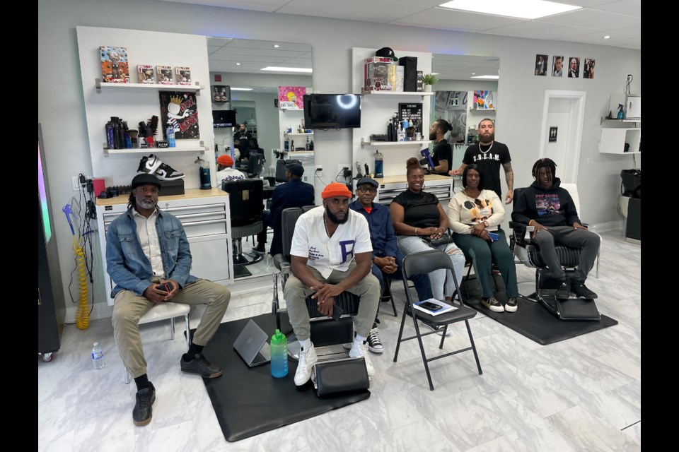 Troy Crossfield (middle), the panellist in Aurora, was joined by others in the community for the Barbershop Talk Series.