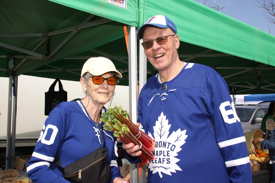 Claire and Glenn MacAlpine pick up fresh rhubarb on opening day of the Newmarket Farmers' Market May 4.