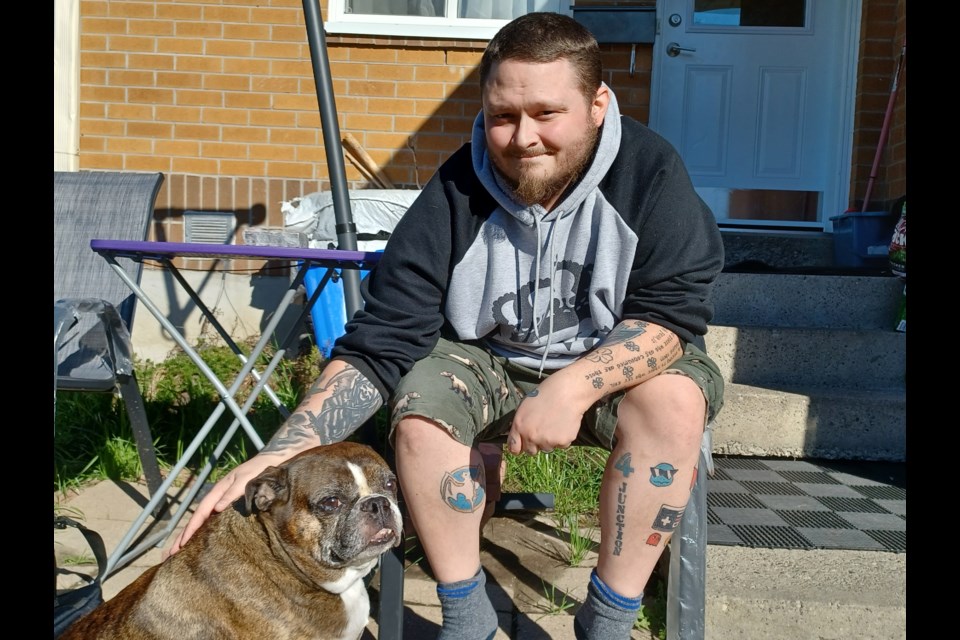 Sean Crilly with his injured dog, Leo. Crilly fundraiser $1,000 to help with medical expenses after his dog was injured in an attack.