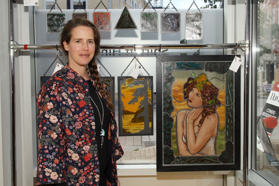 Stained glass artist Jennifer Popp displays her work at the Shirtliff Hinds Law office for the 11th annual Newmarket Group of Artists Art Walk and Studio Tour Saturday.  Greg King for NewmarketToday