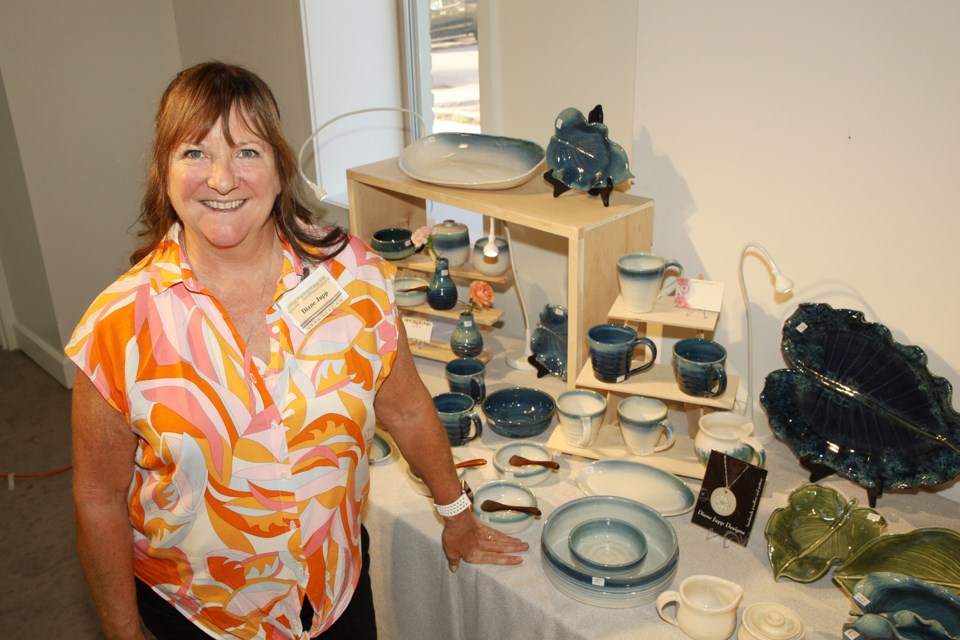 Diane Jupp alongside some of her work at the annual spring sale of the Pine Tree Potters Guild this weekend at the Old Town Hall in Newmarket.  Greg King for NewmarketToday