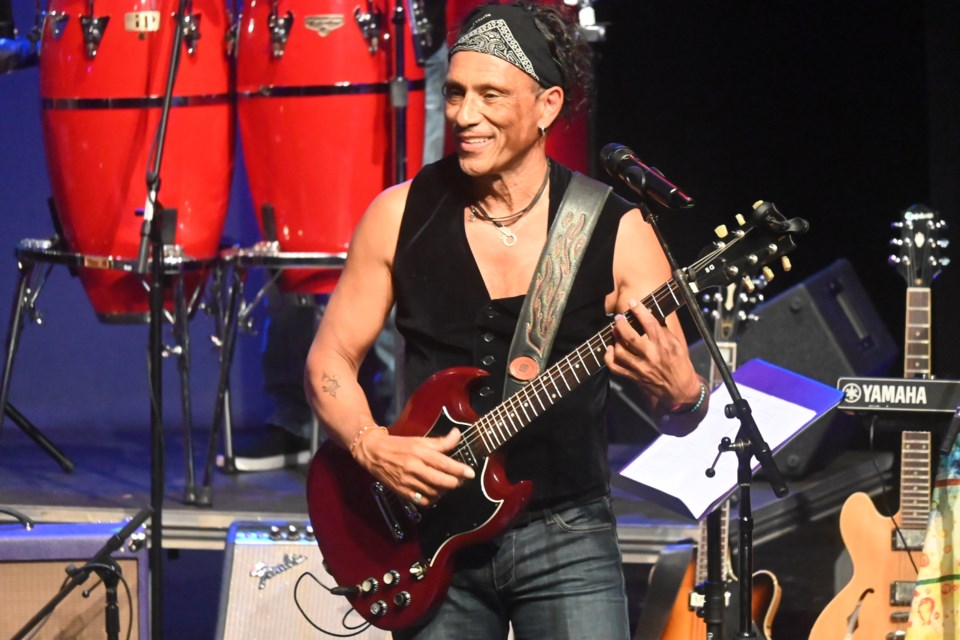Glenn Marais takes the stage imitating Santana for the Woodstock Lives concert at the NewRoads Performing Arts Centre April 13. 