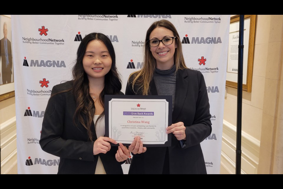 Christina Wang receives her Give Back award with Erin Cerenzia. 