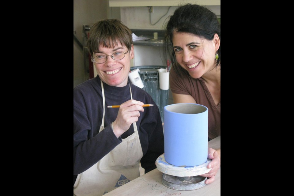 Debbie Dew and Kim creating in the L’Arche Daybreak Pottery Studio. Supplied photo/CFUW