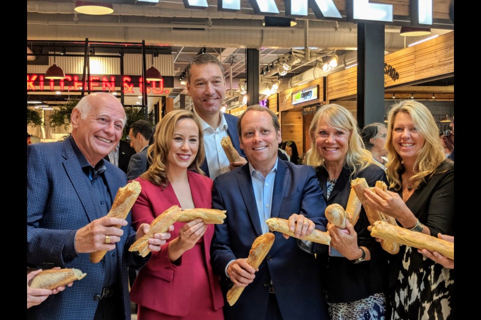 A bread-breaking ceremony officially opens the 40,000-square-feet Market & Co. Shown here (from left) at the Sept. 7 celebrations are Newmarket politicos Mayor Tony Van Bynen, Deputy Mayor and Regional Councillor JohnTaylor, Upper Canada Mall general manager Bri-Ann Stuart, Oxford Properties' head of retail, Bradley Jones, and Councillors Christina Bisanz and Jane Twinney.