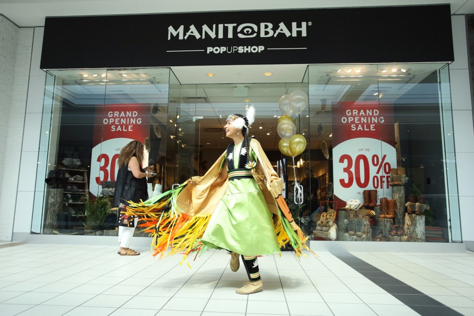 Alexandria Bipatnath dances in front of the new Manitobah Mukluks pop-up shop in Upper Canada Mall at its grand opening Sept. 7.  Greg King for NewmarketToday.