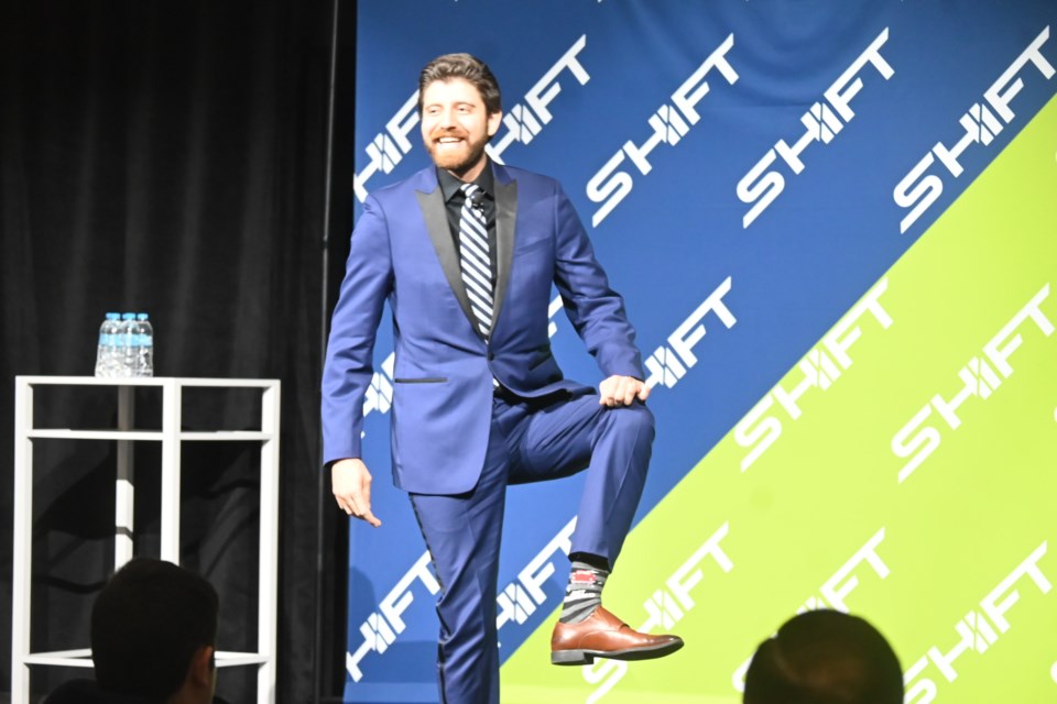 SHIFT23 keynote speaker Tareq Hadhad shows off his just married socks at the conference hosted by the Newmarket Chamber of Commerce in Vaughan May 25.