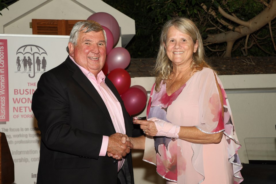 York Region chair and CEO Wayne Emmerson presents Business Women's Network of York Region president Elizabeth Johnston with a 10-year pin award at the annual celebration awards gala last night at Madison Greenhouse in Newmarket.  Greg King for NewmarketToday