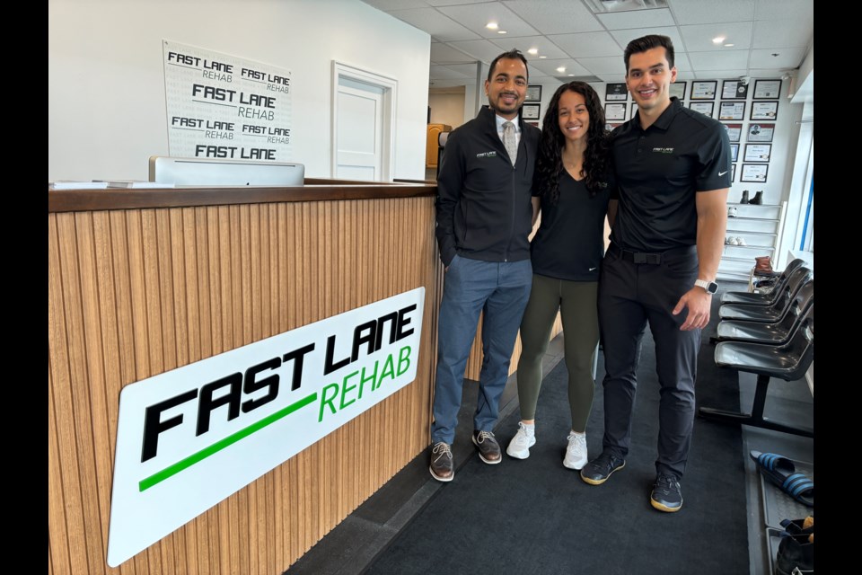 Karma Patel, clinic director (left), Lia Foster, co-owner and personal trainer, and Ruben de Baat, co-owner, mark the grand opening of Fast Lane Rehab April 24.