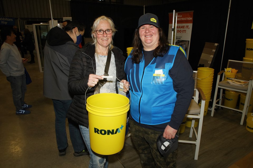 Jen Anderson gets a bucket from Rona's Tara Leerdam at the Newmarket Home and Lifestyle Show, which continues today, April 7, at Ray Twinney Recreation Centre until 5 p.m.