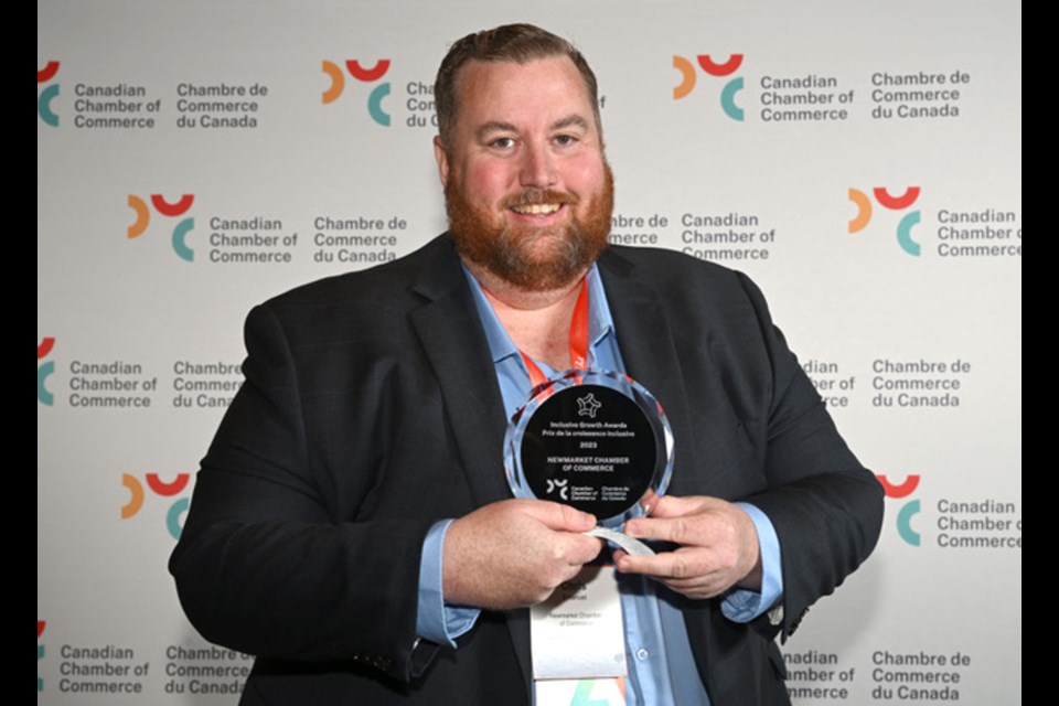 Chris Emanuel, president and CEO of Newmarket Chamber of Commerce, with the Inclusive Growth Award from the Canadian Chamber of Commerce.