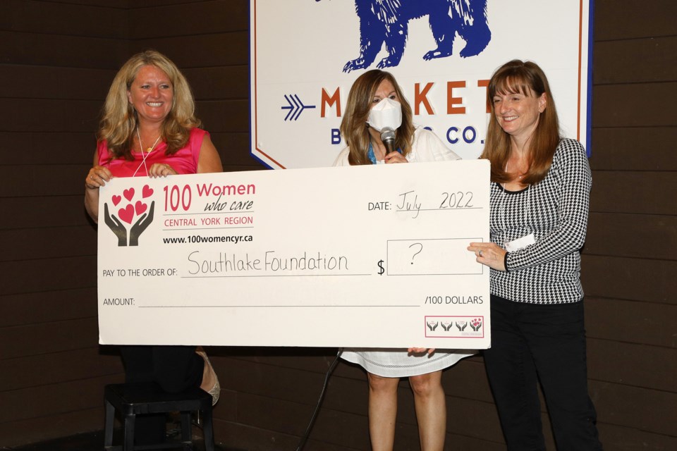 100 Women Who Care Central York Region members Juliane Goyette (from left), Susanne Cappuccitti and Kelly Heinrich announce Southlake Foundation as the next recipient at the first in-person meeting since the pandemic last night, July 27, at Market Brewing Co.  Greg King for NewmarketToday