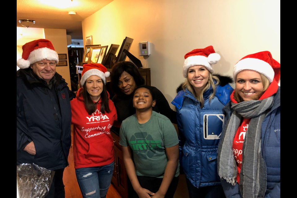 This family was among five in Newmarket, and 12 in total in the region, celebrating a brighter Christmas, thanks to the Random Acts of Christmas by the York Regional Police Association and Jewel 88.5FM. Supplied photo/YRPA