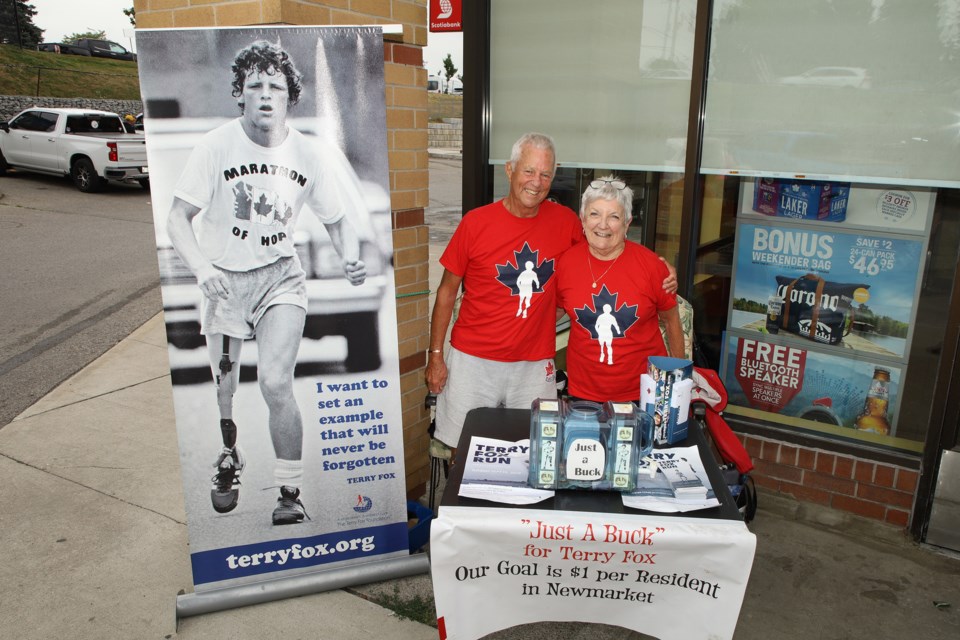 Cancer survivors and Terry Fox Run volunteers Don and Maureen Seller collect donations for the annual Just a Buck campaign at local Beer Stores last Saturday.  Greg King for NewmarketToday