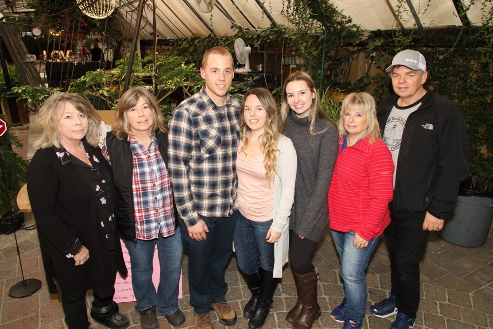 At the Greenhouse Christmas Market yesterday at Madsen's Greenhouse in Newmarket, Kim Fairhurst (from left), Karen Harrison, Cory Harrison, Lindsay Harrison, Tara Campbell, Tammy Campbell, and Dave Campbell. Proceeds support Because Brynlee, a charity founded by Cory and Lindsay in their daughter's honour to help parents who experience baby loss at Mount Sinai Hospital.  Greg King for NewmarketToday