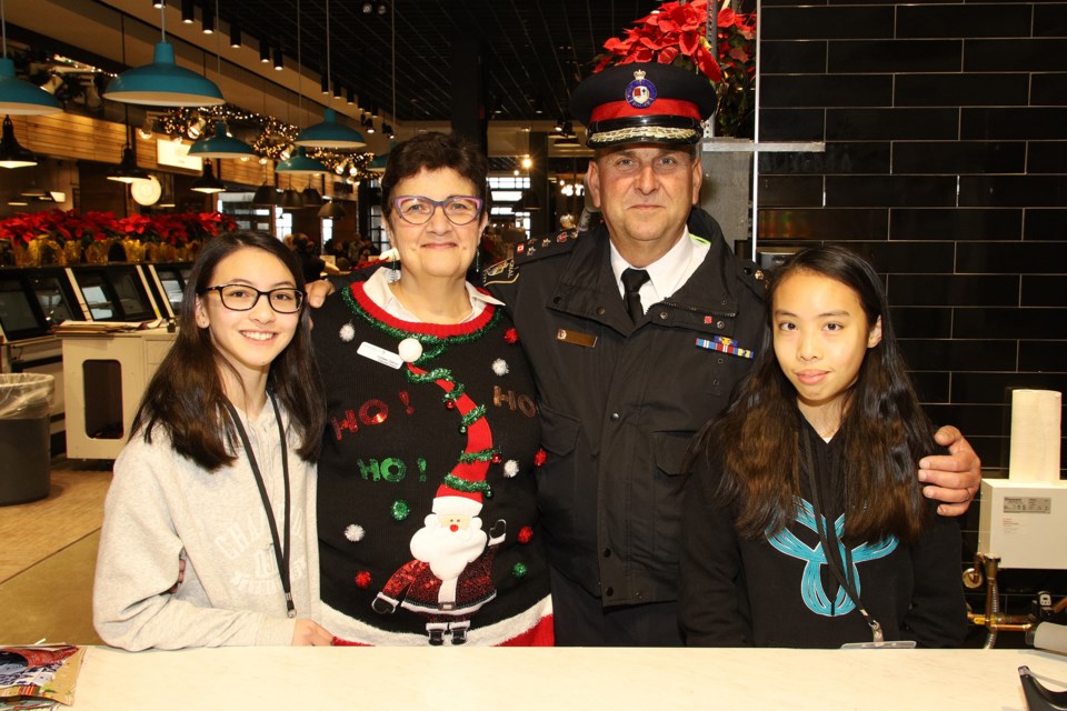 Student volunteer Ava Allen, Community Living Central York executive director Colleen Zakoor, VIP wrapper York Region Police Chief Eric Jolliffe, and student volunteer Emily Lu at the gift wrapping booth inside Market & Co.  Greg King for NewmarketToday