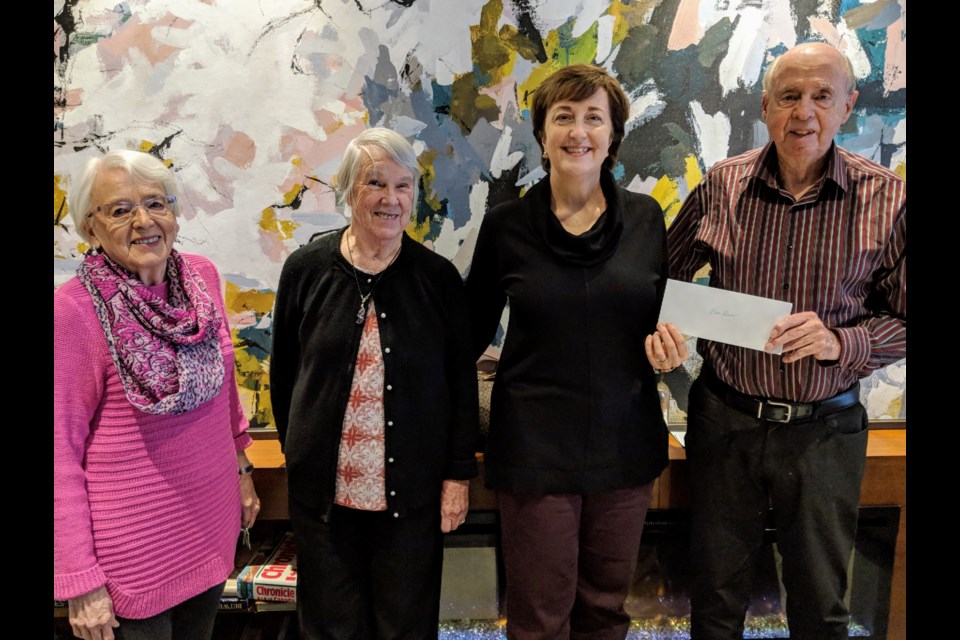The Renoir residents present a $1,500 donation to Blue Door Shelters Jan. 21. Shown here (from left) are Phyllis Savoy, Mary Lou Stanton, Blue Door's Barb Latour, and Jim Stanton. Kim Champion/NewmarketToday