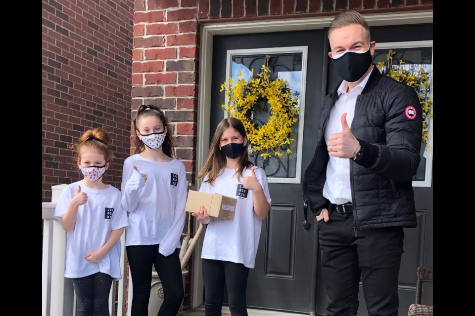 Jason Ofield, Bulk Barn president and CEO, personally drops off 100 gift cards for the food drive organized by sisters Stella, 11, Portia, 9, and Violet, 7, and their Lil Big Kid Squad.