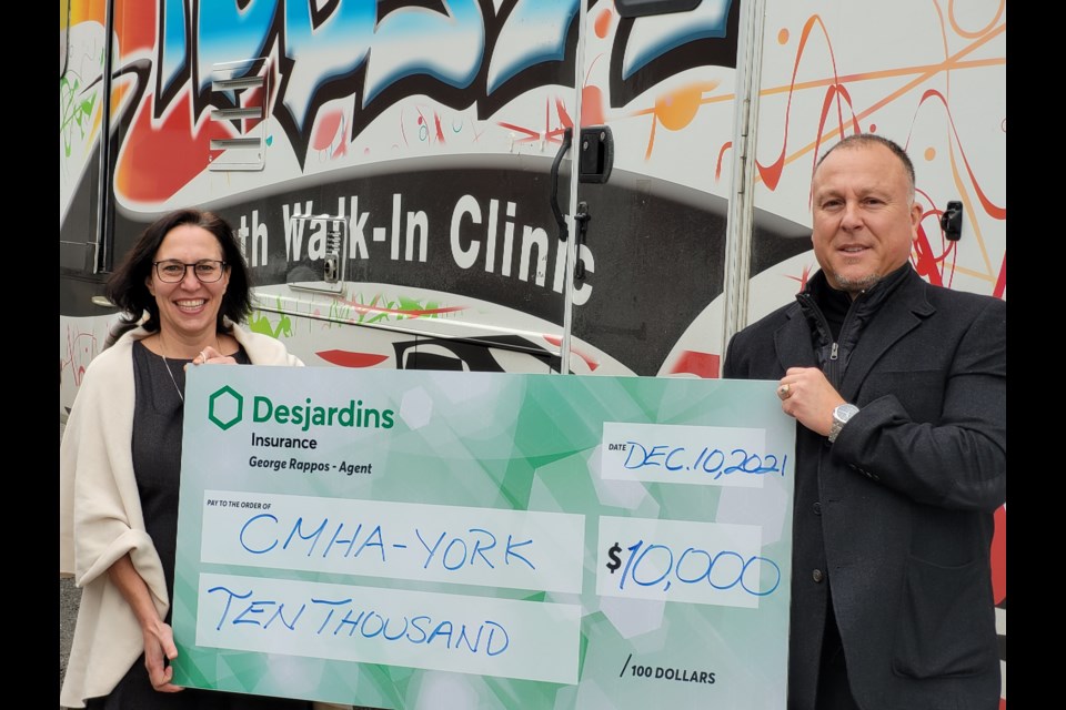 CMHA-YRSS CEO Rebecca Shields and George Rappos with the ceremonial cheque for $10,000. 