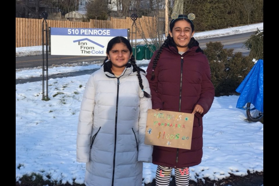 Manha and Laiba Yusuf in front of the shelter, where they dropped off the donations from their latest fundraiser. 