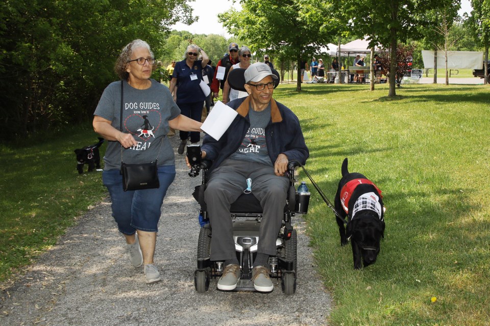 Tina and Rami Abu Ithar, along with dog guide Eagle, take part in the Pet Valu Walk for Dog Guides June 4 in Newmarket.  Rami is a beneficiary of the Lions' service dog program. Greg King for NewmarketToday