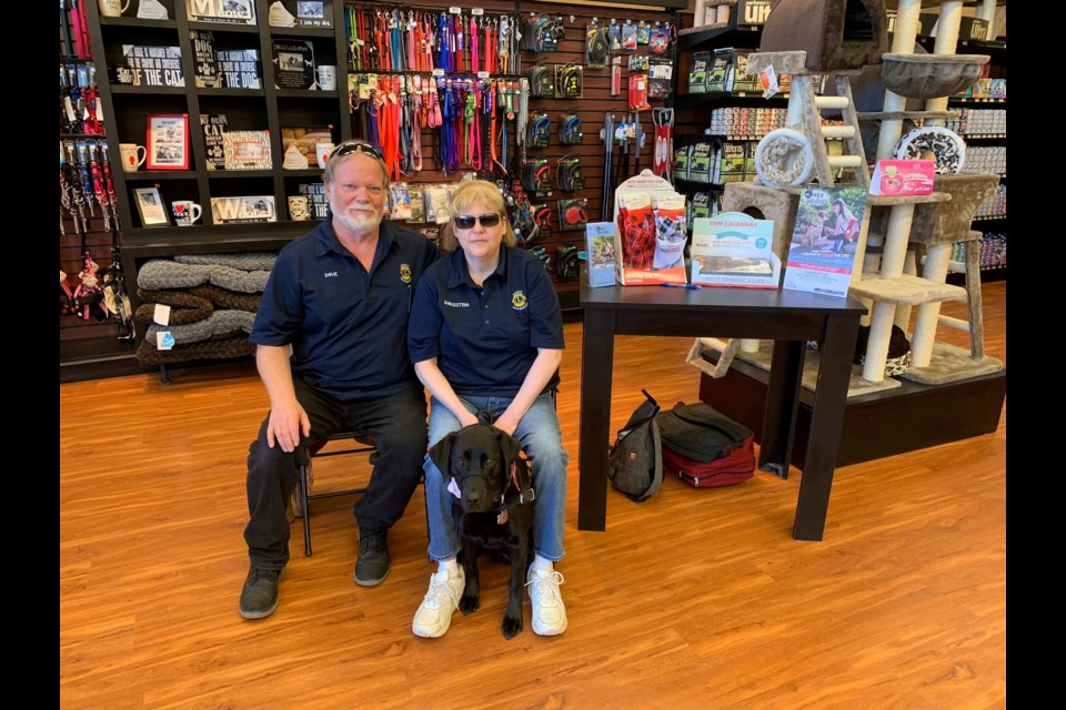 Lions Dave and Khrisstina Engel and dog guide Nutmeg promote the Pet Valu Walk for Dog Guides at the Aurora Pet Valu.