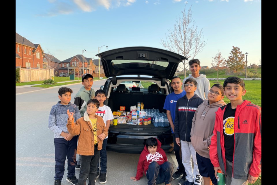 Local Ahmadiyya Muslim Children's Association members donate 60 lbs of food in support of Aurora Food Pantry