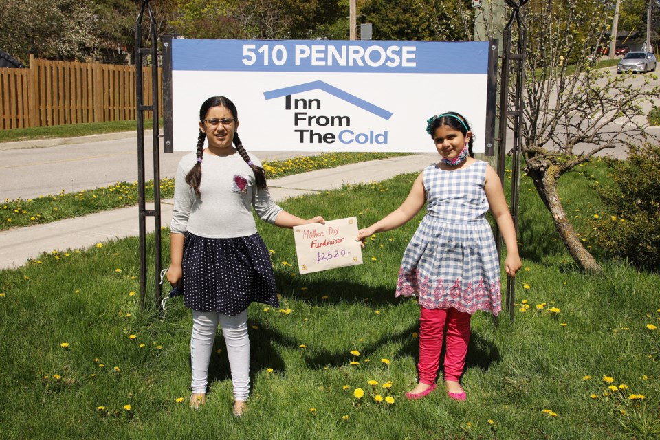 Manha and Laiba Yusuf donate $2,520 from their Mother's Day fundraiser to Inn From the Cold.  Greg King for NewmarketToday