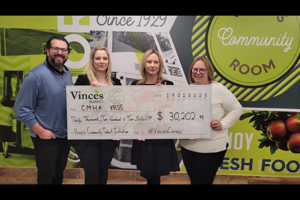 Giancarlo Trimarchi (from left) and Maria Ciarlandini of Vince's Market present a cheque to Catherine Matzig, senior director of philanthropy at CMHA York Region South Simcoe, and Theresa Scullion,  philanthropy committee member. 