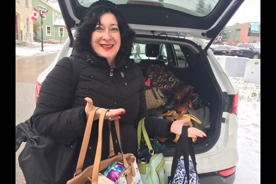 Angel Freedman's SUV is always full with donations of purses for local shelters. Debora Kelly/NewmarketToday