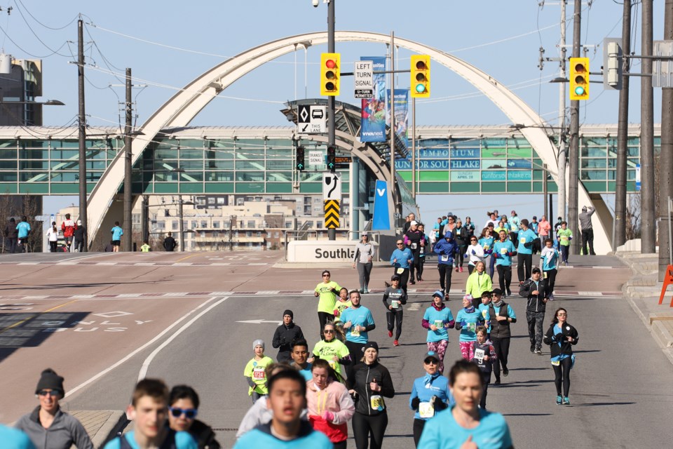 Runners pass under the Southlake Arch.  File photo/ Greg King for NewmarketToday