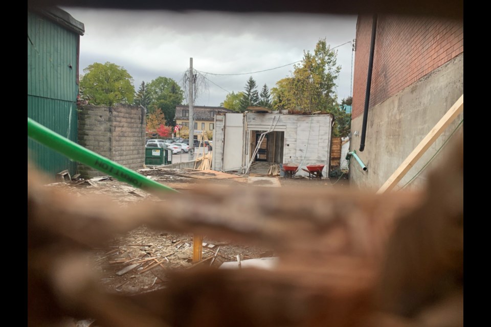 Through the peephole in the hoardings on Main Street, you can see the gaping hole where Newmarket's historic circa-1850 Charles Hargrave Simpson building used to stand at 184 Main St. S. Debora Kelly/NewmarketToday