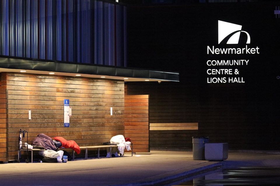 Despite a notice issued by the Town of Newmarket, homeless individuals continued to sleep on benches outside the community centre at Riverwalk Commons last summer. File photo/Greg King for NewmarketToday