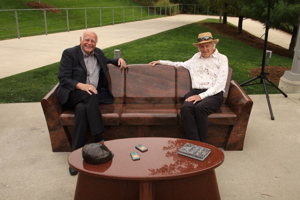 Newmarket-Aurora MP and former longtime mayor Tony Van Bynen and the artist Edward Falkenberg at yesterday's unveiling of the public art installation.  Note that social distancing can be maintained while sitting on all the parts of the sculpture.  Greg King for NewmarketToday