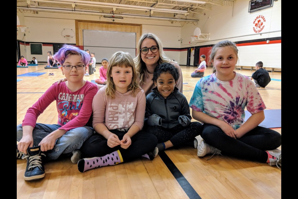 Grades 2/3 teacher Madison Macken is shown here after a Thursday lunchtime yoga class with students (from left) Nevaeh Bassoukos, Emma Parsons, Jireh Andrews, and Kaitlin Pelekis-Murray. Kim Champion/NewmarketToday