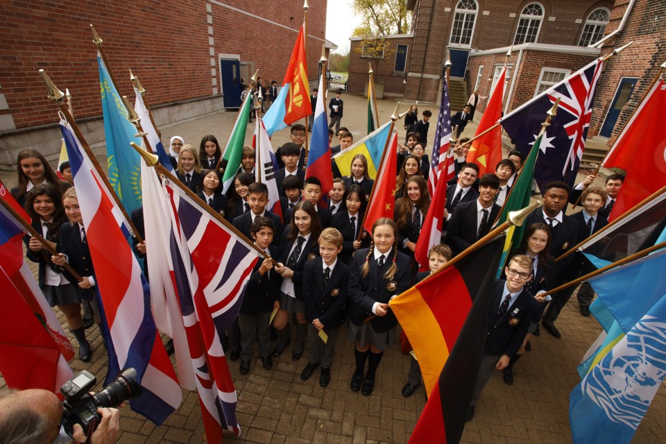 Students marched in a parade carrying the flags of the 28 United Nations member states represented at Pickering College to mark the anniversary of the 1945 UN Charter Oct. 24.  Greg King for NewmarketToday