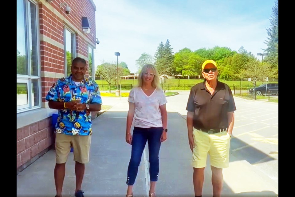 Javed Khan, Michelle Worville, and Glen Stainton outside the new Rogers Public School. 