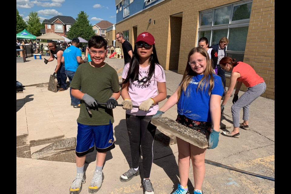 St. John Chrysostom CES students Carlo Cioffi, Arian Juanico and Alexis Totten get down to work. Debora Kelly/NewmarketToday