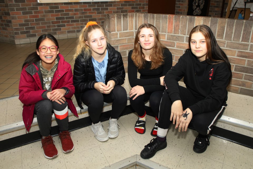 St. Paul Catholic Elementary School Grade 8 students Caitlyn Chui, Melanie Sipos, Addison Green, and Samantha Smith are part of a student-led initiative to create a positive affirmation banner in response to racist graffiti that defaced the outside wall of their school.  Greg King for NewmarketToday