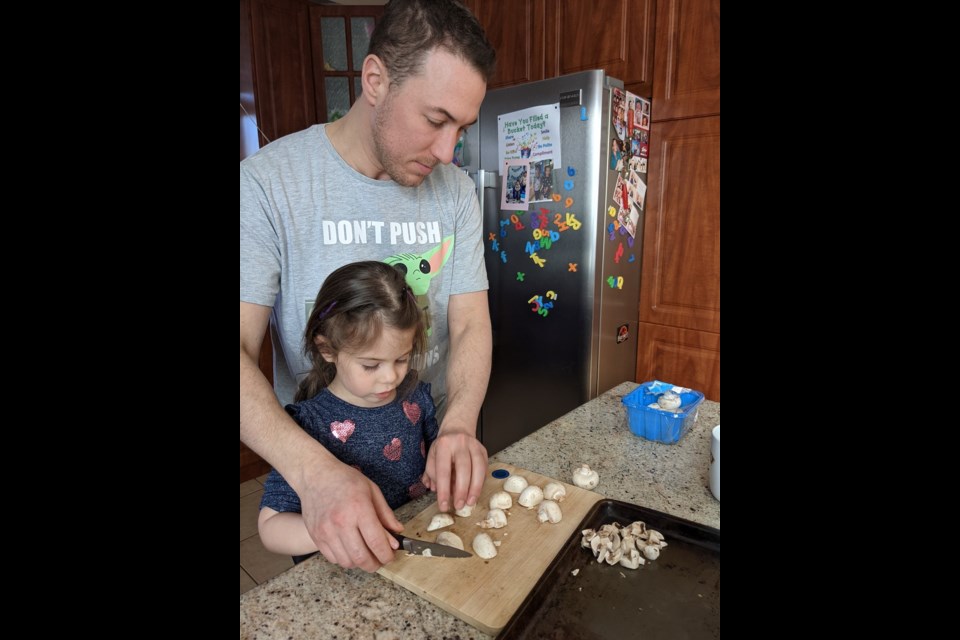 Chef Julian Pancer of The Chef Upstairs and Remi cutting mushrooms. Supplied photo