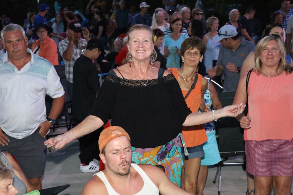 Newmarket's Tracee Chambers dances to Beatles tribute band the Liverpool 4 at Thursday night's TD Music Series concert at Riverwalk Commons in downtown Newmarket.  Greg King for NewmarketToday
