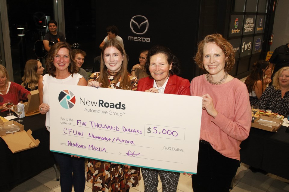 Cecily Hennessey and Rachel Hawtin (left) of NewRoads Automotive Group present a cheque for $5,000 to Donna Wright and Michelle Black of CFUW Aurora-Newmarket last night at the Charcuterie and Chardonnay event hosted by at NewRoads Mazda Friday night in Newmarket in support of scholarships for women.