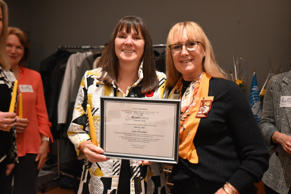 Zonta Club of Central York president Marion Reeves accepts a certificate from district governor Sheena Poole during the club's chartering ceremony Nov. 7.