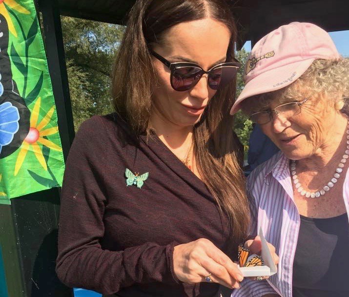 Juliana Playter and Elisabeth Hempen have a close look at a butterfly at last year's Memorial Butterfly Release. Photography by Bereaved Families Ontario-York Region.