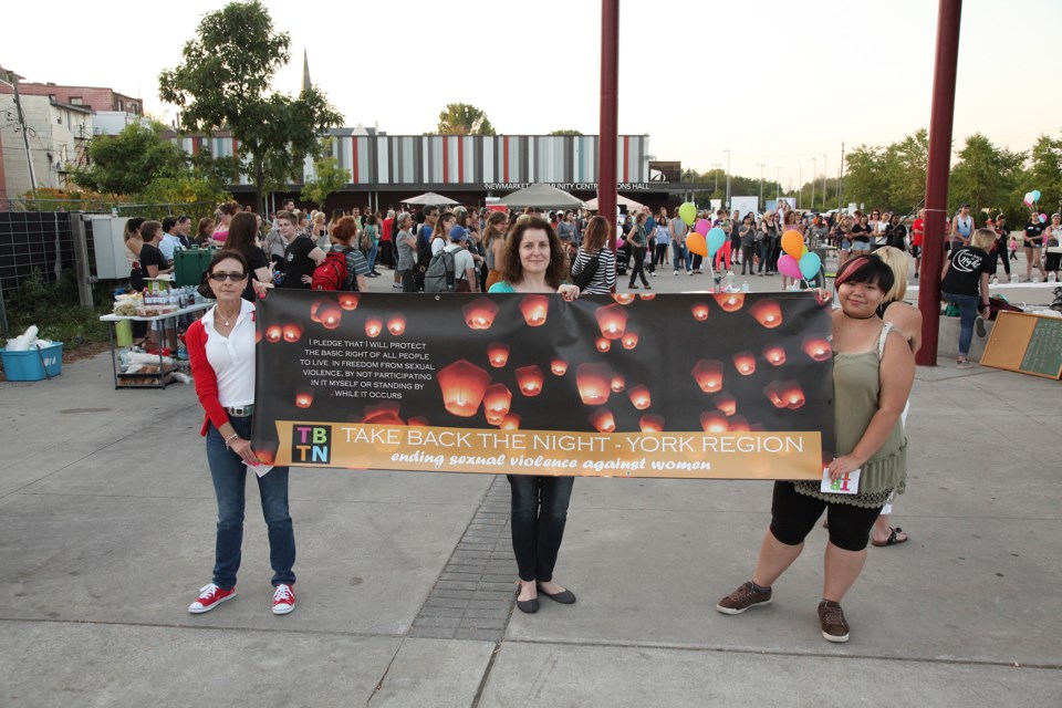 Participants ready to march at last year's Take Back the Night event at Riverwalk Commons. Photography by Greg King.
